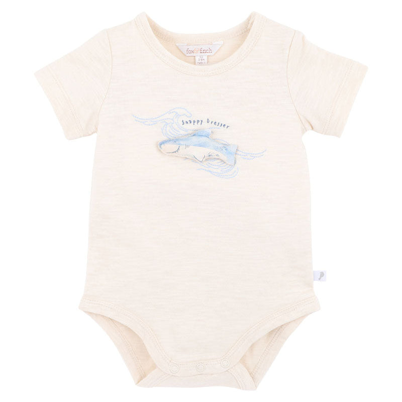 Baby short sleeved onesie with embroidered blue shark motive and snappy dresser words on a natural 100% cotton fabric