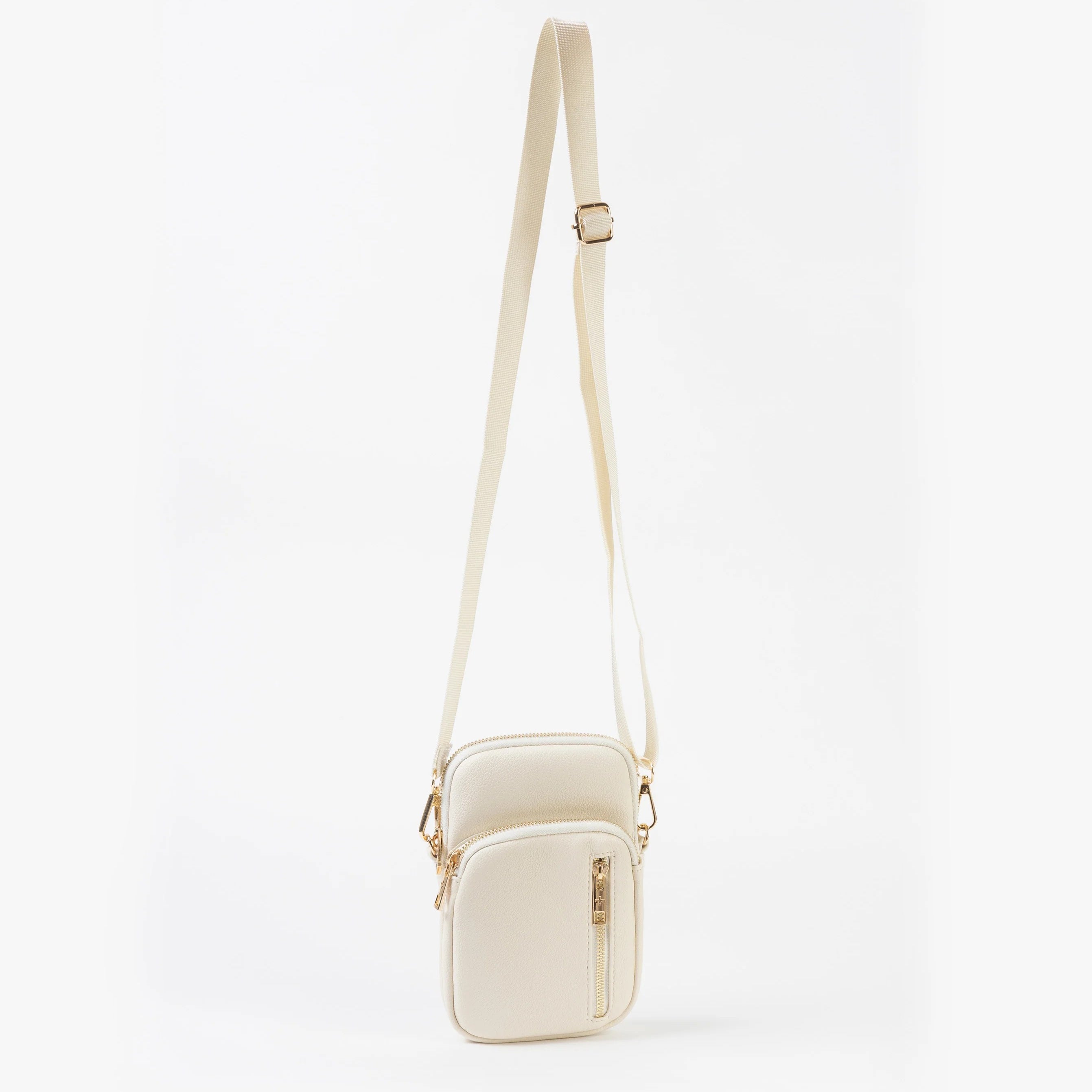 White crossbody bag on a light beige background