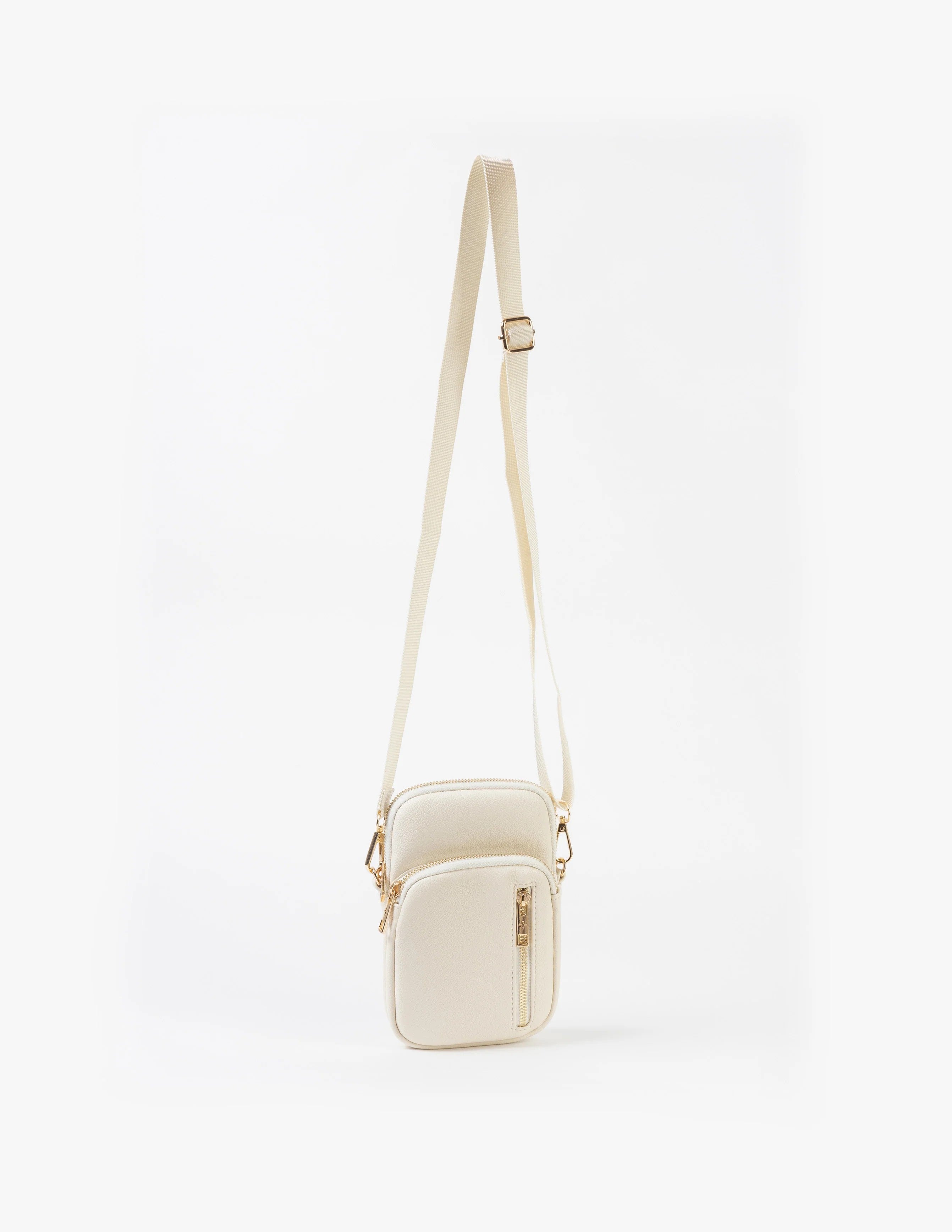 White crossbody bag on a light beige background