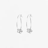Pair of silver hoop earrings with floral designs on a white background