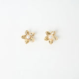 Gold flower shaped beaten earrings with pearl in the centre