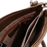 Close-up of a brown leather handbag with a zipper, showing the interior.