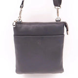 Navy leather crossbody bag with a strap on a white background
