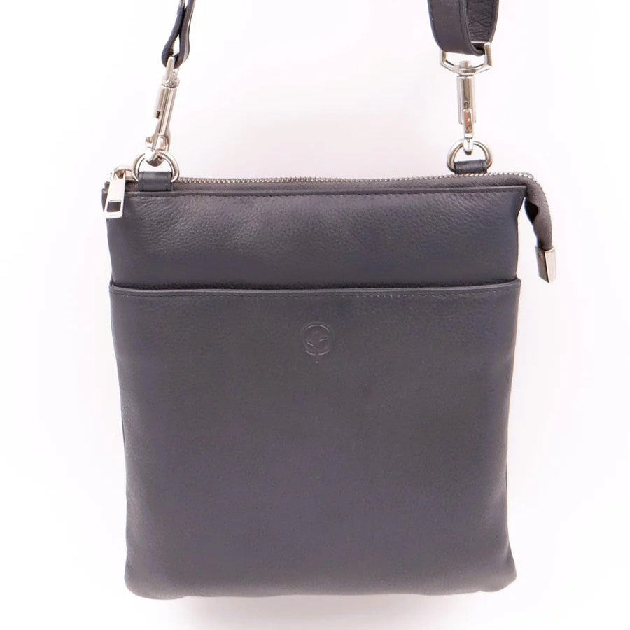 Navy leather crossbody bag with a strap on a white background