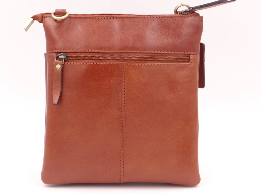 tan leather crossbody bag on a white background