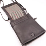 Black leather crossbody bag with plaid interior on a white background