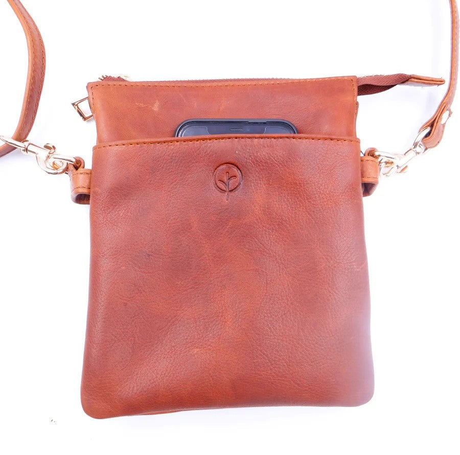 Tan leather crossbody bag with a phone pocket on a white background
