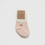 Over the Dandelions Set of 2 Baby Socks insoft blush pink and Ivory with a cherry motif design at Cerise. Made from soft organic cotton to fit newborn babies size 0 to 6 months.