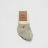 Over the Dandelions Set of 2 Baby Socks in sage green and ivoryMushroom design at Cerise. Made from soft organic cotton to fit newborn babies size 0 to 6 months. A great baby shower gift.