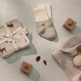 Over the Dandelions Set of 2 Baby Socks in sage green and ivoryMushroom design at Cerise. Made from soft organic cotton to fit newborn babies size 0 to 6 months. Shown with Woodland Wash Cloths for a newborn baby gift idea.