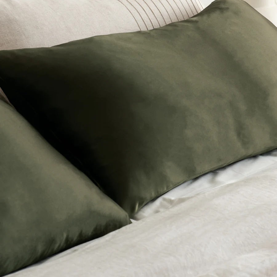 Olive green silk pillowcase on bed