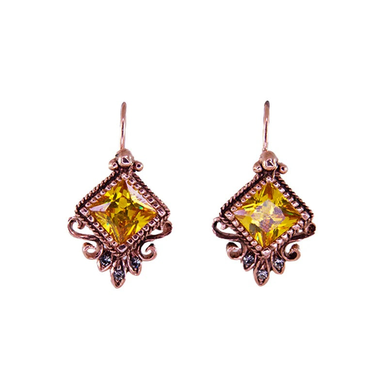 Simply Italian Earrings freaturing a large genuine Bright Citrine Swarovski crystal centre stone with  three sparkling fumé Swarovski crystal accents.  Intricate Baroque-inspired design made from 18ct rose gold plate over 925 sterling silver
Size: 18mm wide × 32mm high (including hook)
Hook-style earrings
Made in Italy at Cerise
