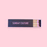 Black Box of Matches with Sunday Culture Brand in Pink writing on the front.