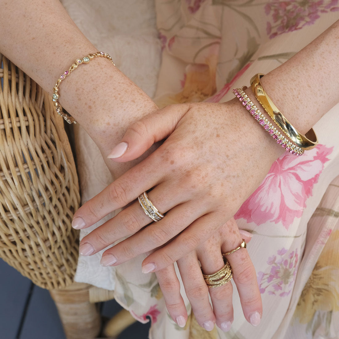 A&C Oslo  multistone  bacelet from the Sweet Droplets collection, featuring beautiful soft multi coloured  crystals and 14K gold plate beads.Layered on a model with a solid 14K gold plate bangle and colourful Pink and green Friendship  bracelet at Cerise NZ.
