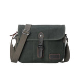 Troop London Nomad 440 Cross Body Bag at Cerise. Fully lined small travel bag with deep compartments, zip closure and phone compartment. Measures H21 x W26 x D10cm. Made of waxed canvas, shown here in dark green.