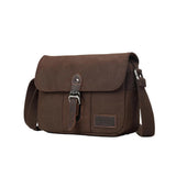 Troop London Nomad 440 Cross Body Bag at Cerise. Fully lined small travel bag with deep compartments, zip closure and phone compartment. Measures H21 x W26 x D10cm. Made of waxed canvas, shown here in dark brown.