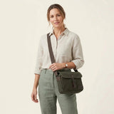 Troop London Nomad 440 Cross Body Bag at Cerise. Fully lined small travel bag with deep compartments, zip closure and phone compartment. Zip enclosure on back of bag. Measures H21 x W26 x D10cm. Made of waxed canvas, shown here in dark green.