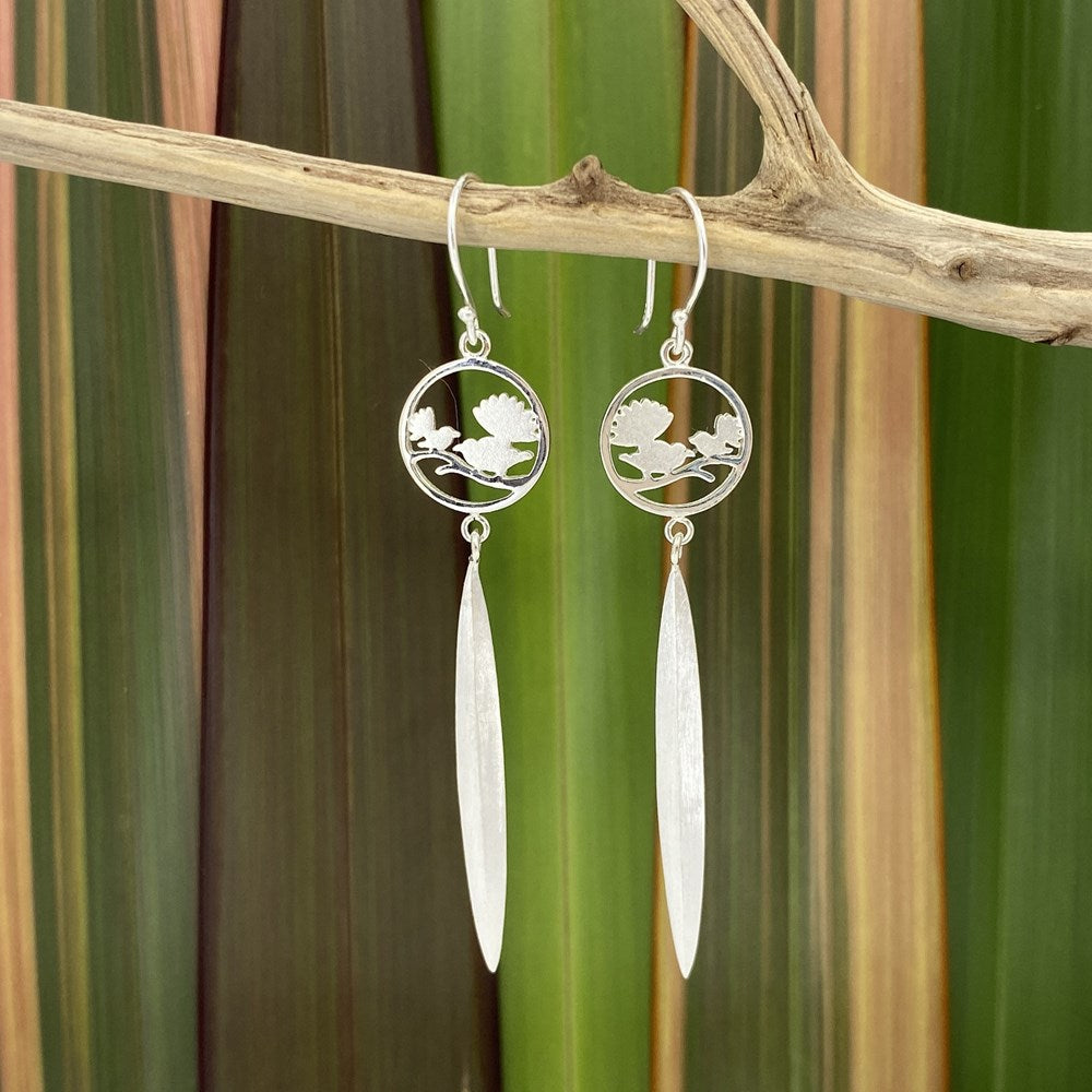Silver Earrings with two NZ native fantail birds sitting in a circle and a flax leaf drop