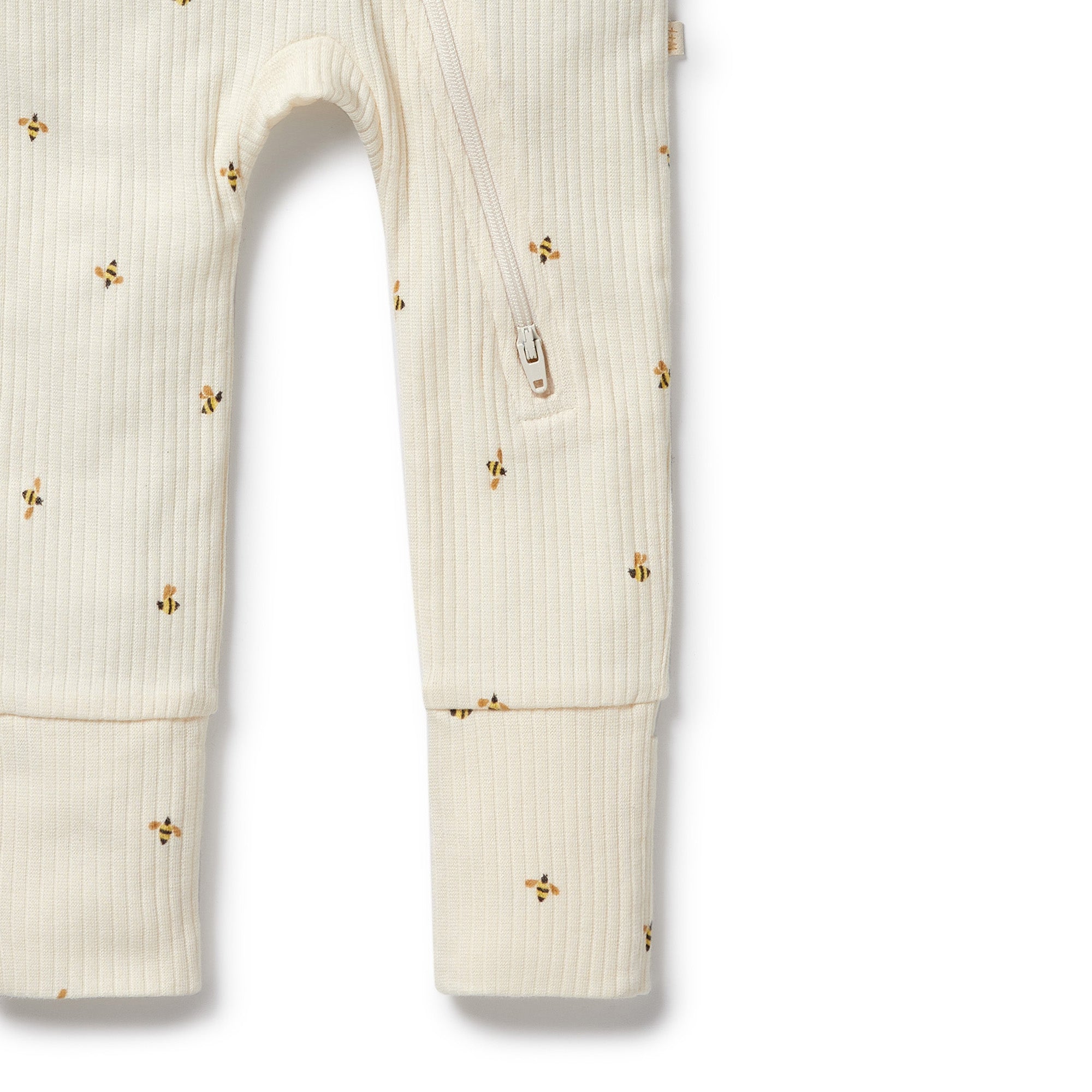 Legs of bee patterned onsie showing footed cuf