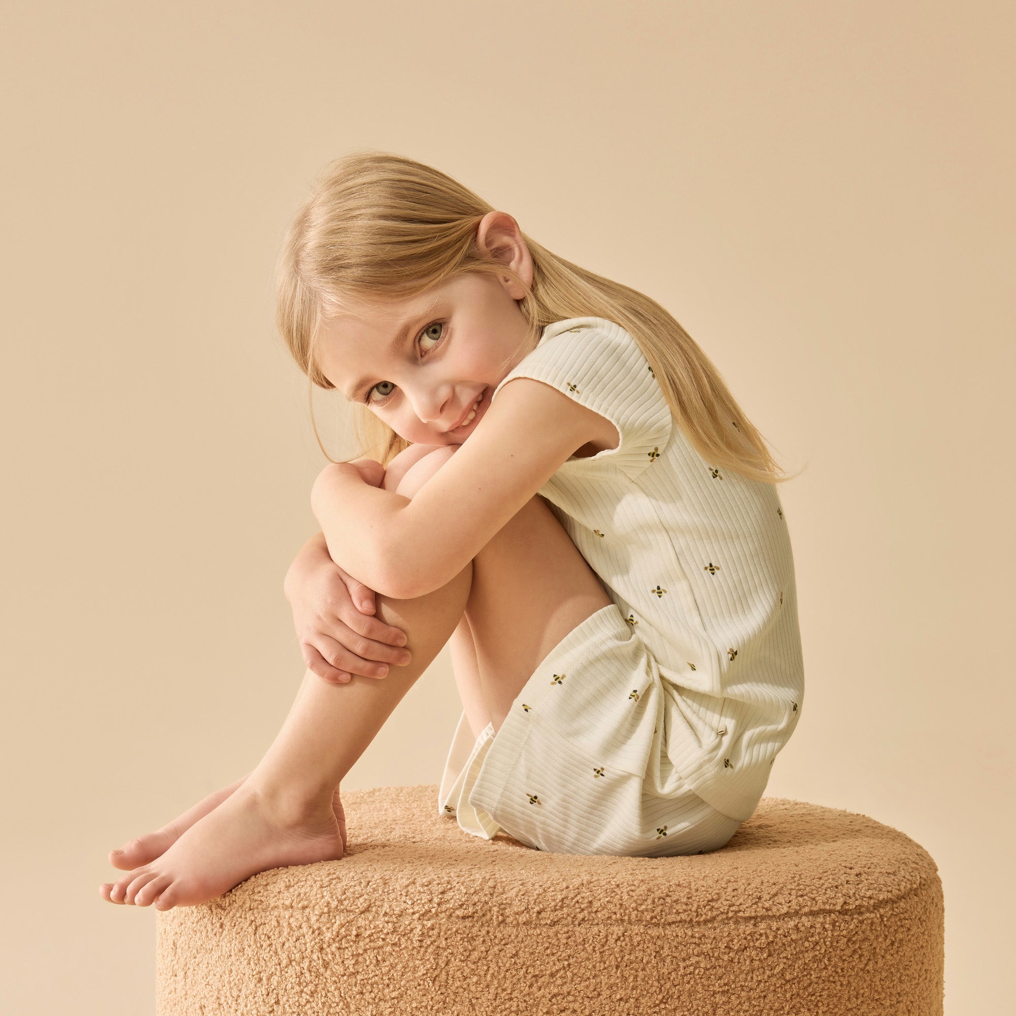 Child wearing bee print cotton pyjamas