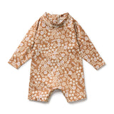 Boyleg swimsuit in floral patttern on brown background - front view