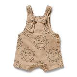 Caramel base with brown sun faces baby overall with tie straps, front pocket and crotch dome opening.  Short legs - Front view