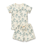 Short sleeved kids pyjamas ith a green yeti pattern on a natural coloured cotton background
