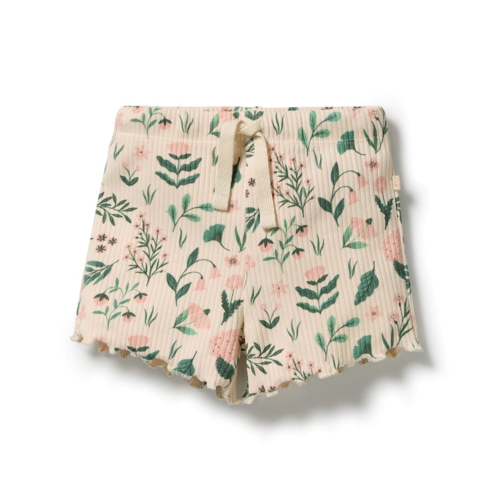 Wilson & Frenchy Sweet Bloom Organic Short in cotton drop needle at Cerise. Designed with a comfortable slim fit, these organic cotton shorts feature a soft elasticated waistband and adjustable ties for an easy, secure fit. The functional drawstring adds practical detail, while the delicate babylocked hem gives these kids’ shorts a sweet, refined finish.