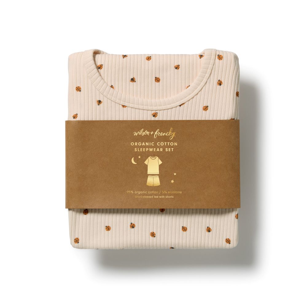 Wilson & Frenchy Little Lady Bugs Organic Short Sleeved Pyjamas at Cerise. Made from GOTS-certified organic cotton in a lightweight drop-needle fabric, this two-piece kids’ sleepwear set offers breathable comfort for a restful night’s sleep. The set includes a short-sleeved T-shirt and relaxed, mid-length shorts, making it an easy and practical choice for warmer weather.