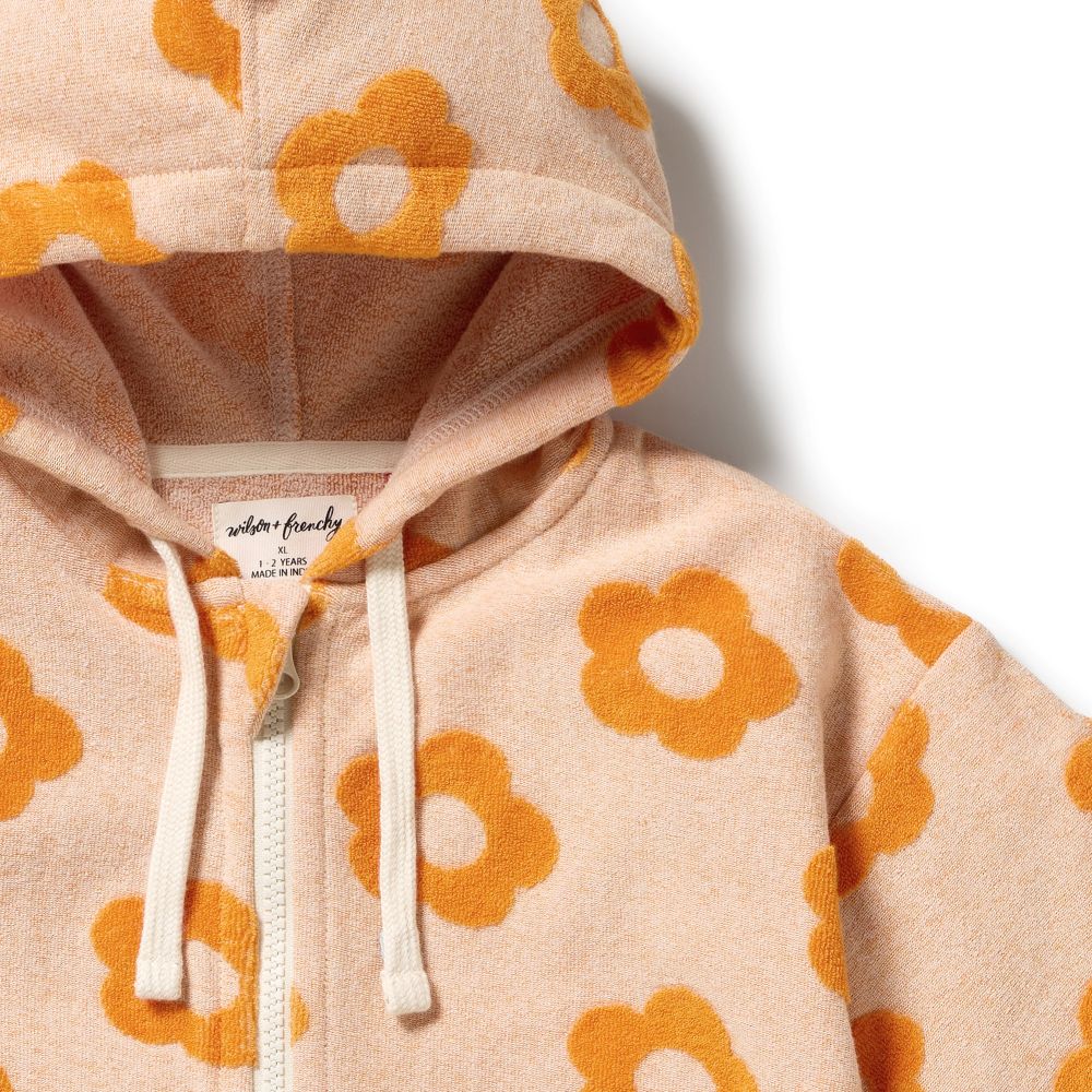 Wilson & Frenchy Daisy Glow Organic Terry Hooded Towel at Cerise. Designed with a practical zip-up front, this mid-length hooded towel is easy to pop on when it’s time to get dry. The relaxed fit allows plenty of room for comfortable movement, while two handy front patch pockets provide a practical place for little hands or small treasures.