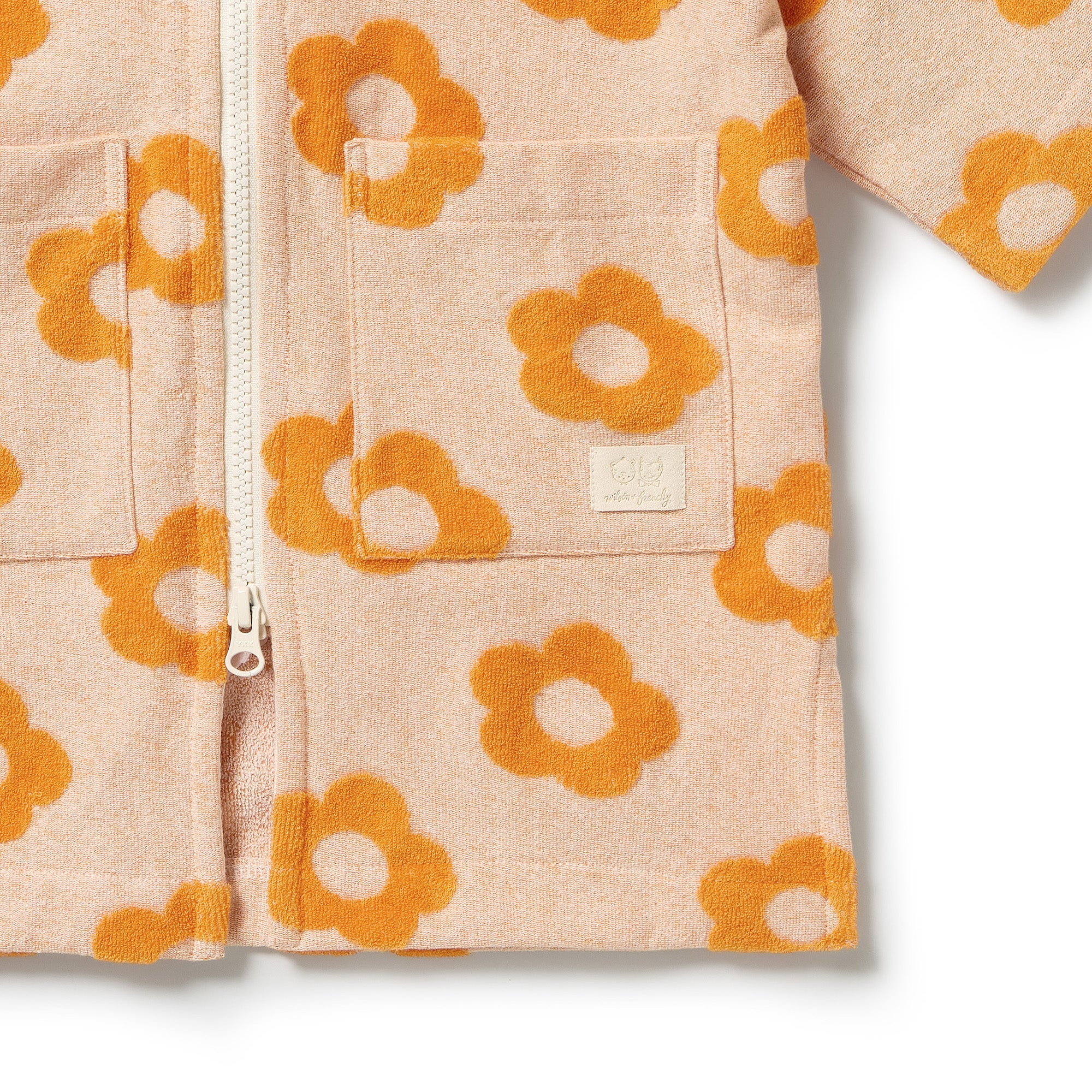 Wilson & Frenchy Daisy Glow Organic Terry Hooded Towel at Cerise. Designed with a practical zip-up front, this mid-length hooded towel is easy to pop on when it’s time to get dry. The relaxed fit allows plenty of room for comfortable movement, while two handy front patch pockets provide a practical place for little hands or small treasures.