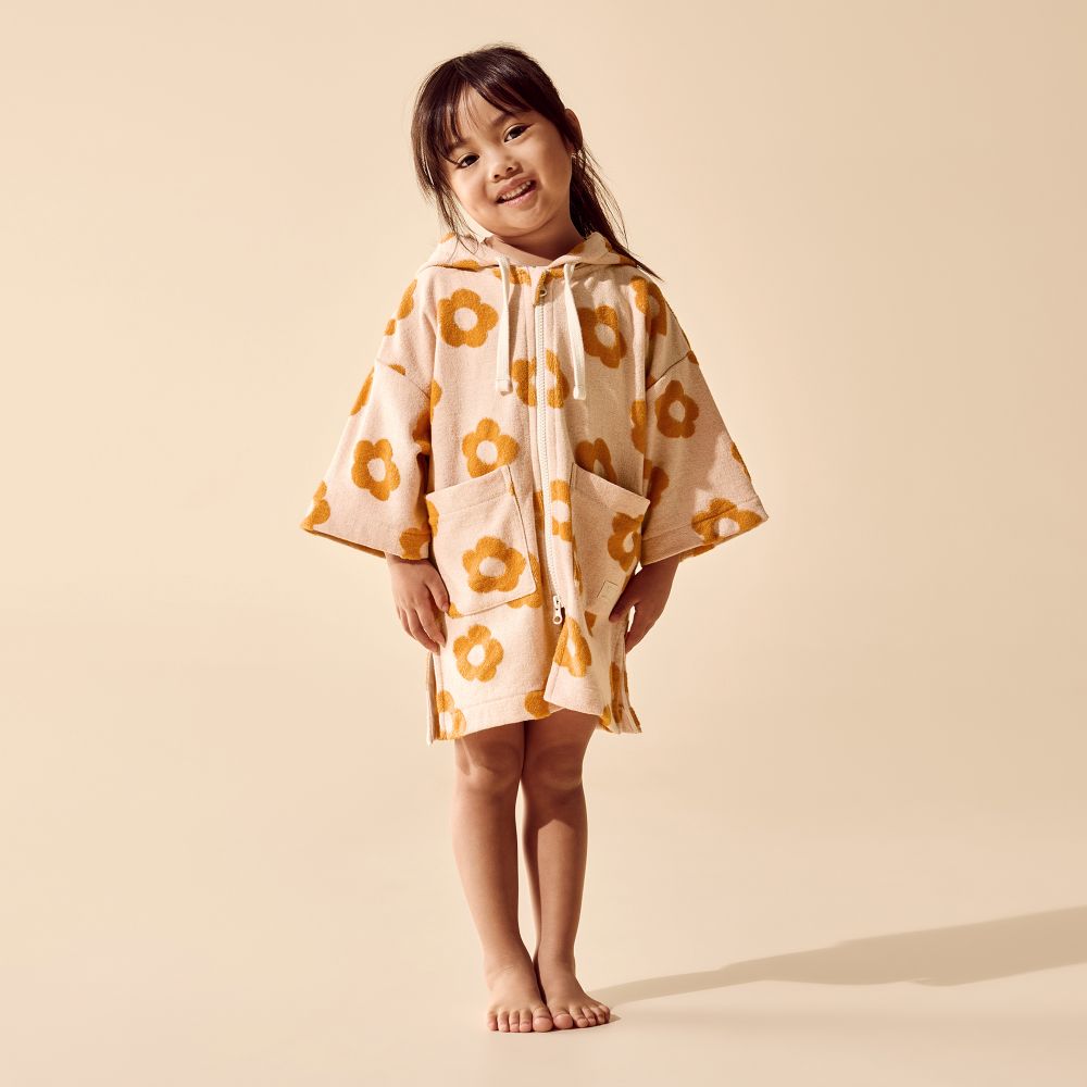 Wilson & Frenchy Daisy Glow Organic Terry Hooded Towel at Cerise. Designed with a practical zip-up front, this mid-length hooded towel is easy to pop on when it’s time to get dry. The relaxed fit allows plenty of room for comfortable movement, while two handy front patch pockets provide a practical place for little hands or small treasures.