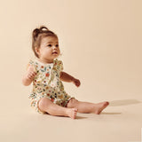 Wilson & frenchy Summer Garden Organic Ruffle Zipsuit at Cerise. Featuring an enchanting all-over Summer Garden print, this baby zipsuit is finished with adorable ruffle cap sleeves for a playful, feminine touch. The comfortable design allows plenty of freedom for little ones to move, play and explore.

A convenient two-way zip through the centre front makes dressing and nappy changes quick and easy, while shirring around the leg openings provides a flexible, comfortable fit that accommodates growing babies