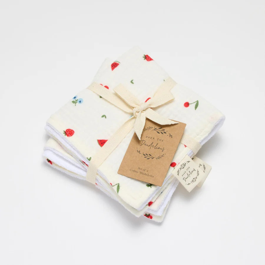 Over the Dandelions Set of 2 Baby Wash cloths in Sweet Pickings design at Cerise.  Featuring  a gorgeous fruit picking pattern of strawberry, cherry and watermellon.Made from 100% organic cotton muslin and cotton terry.