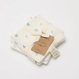 Over the Dandelions Set of 2 Baby Wash cloths in Enchanted Garden  design at Cerise.  Featuring  a gorgeous  pattern of  soft blue icons on a neutral background. Made from 100% organic cotton muslin and cotton terry.