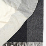 Weave Bayswater Charcoal Throw at Cerise.  Made in 100% New Zealand Wool in a check design in varying shades of charcoal.  Has fringed ends and throw measures 150cm x 240cm