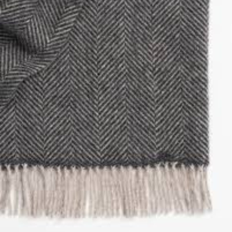 Weave Lerwish 100% NZ wool throw in a charcoal herringbone pattern with tassels