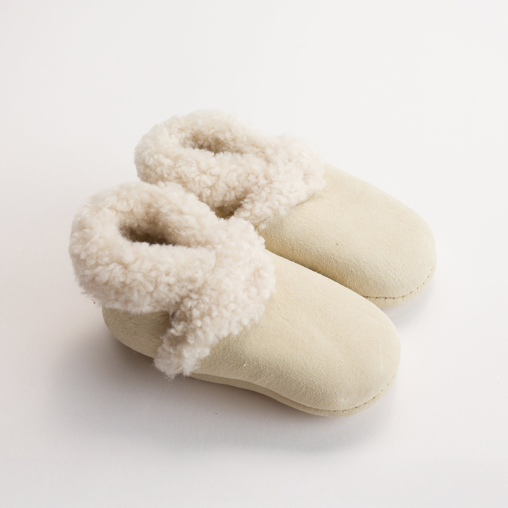 Woolbabe Lambskin Booties for baby in a soft natural Toetoe colourway at Cerise. Made in New Zealand.