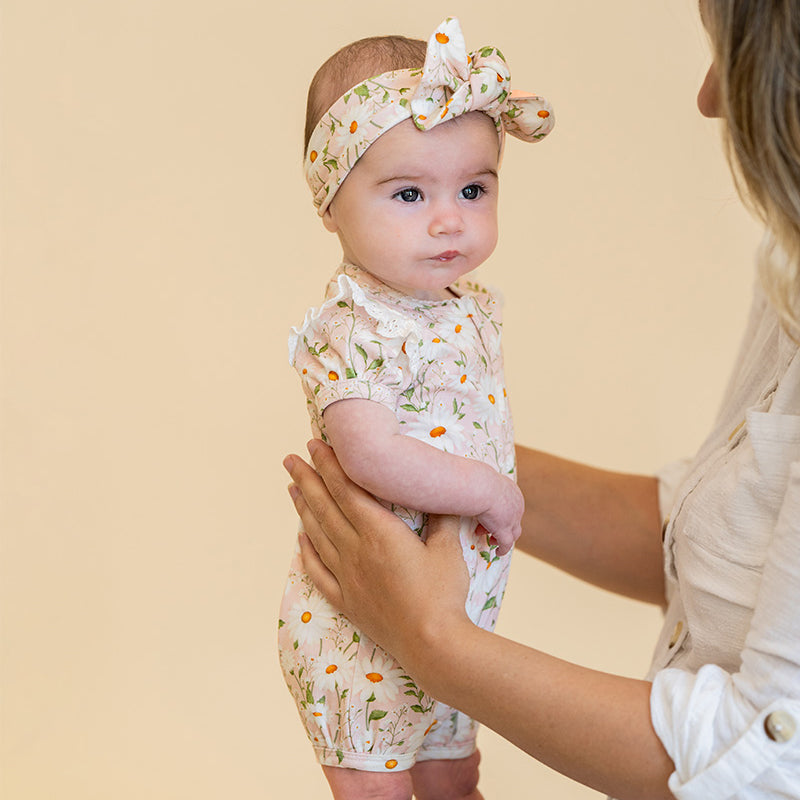 Baby wearing a floral outfit
