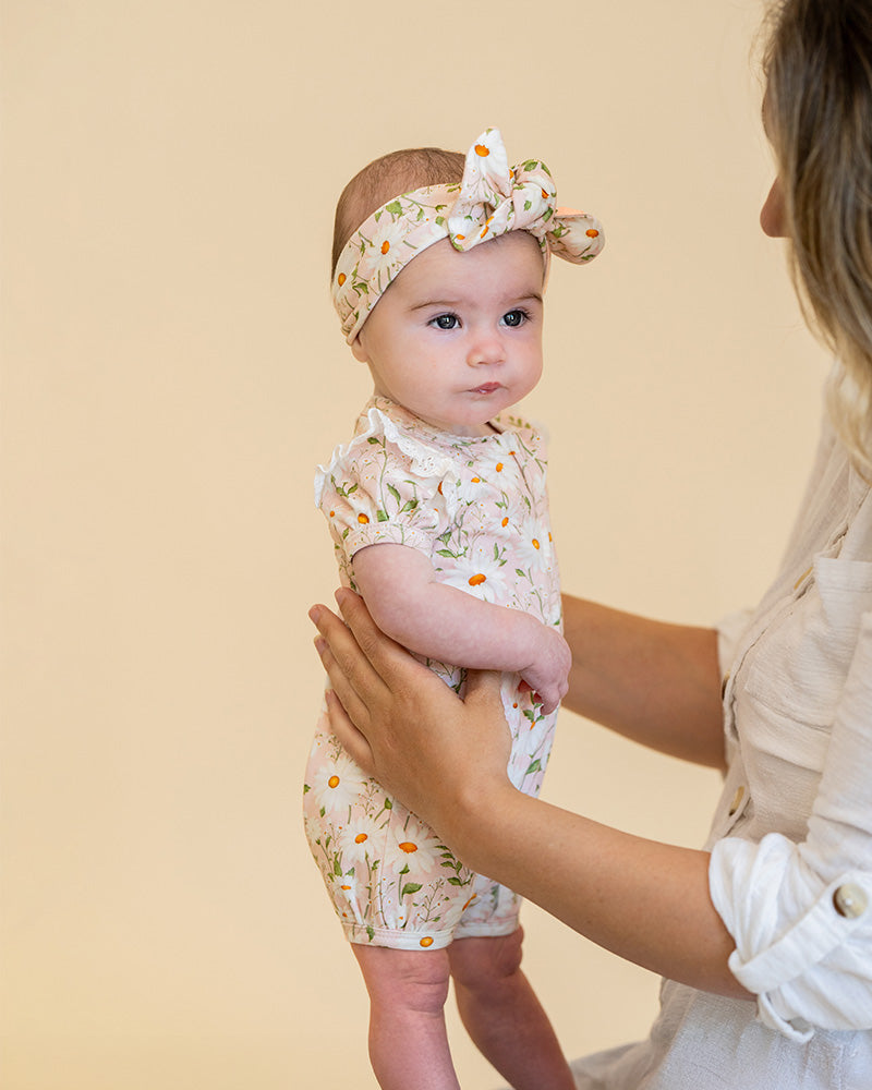 Baby wearing a floral outfit