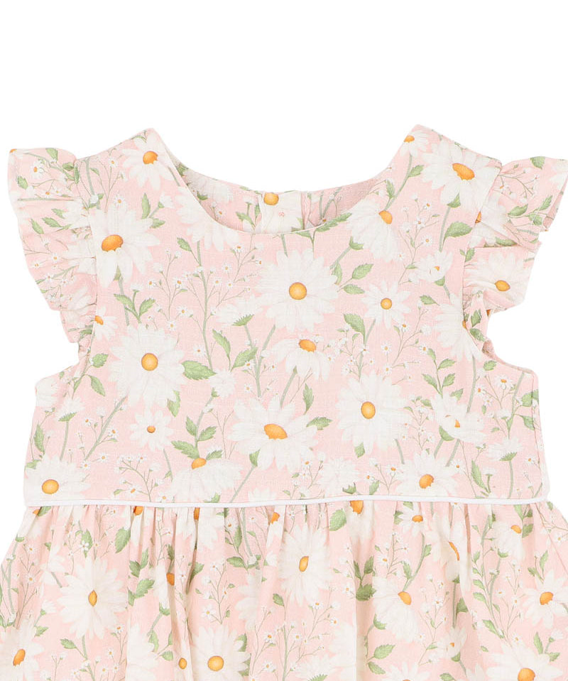 Floral dress with ruffled sleeves with white daisys on a pink background