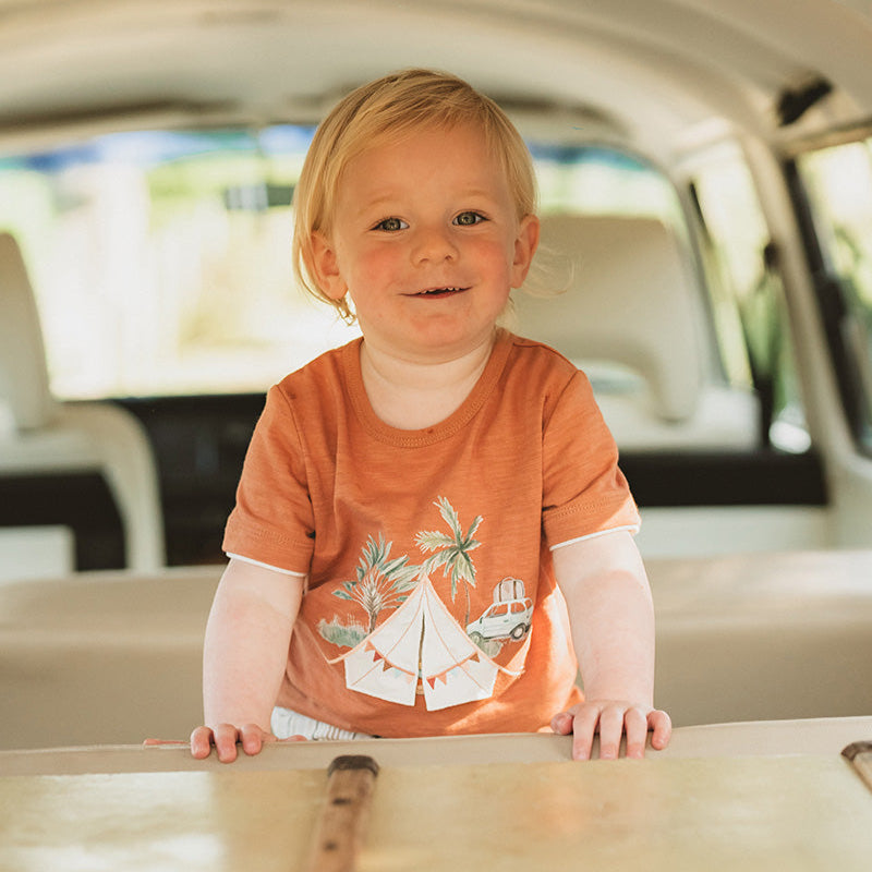 Childrens rust coloured tee shirt with a campling graphic on the front