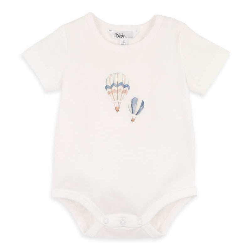 White baby onesie with hot air balloon design on a white background