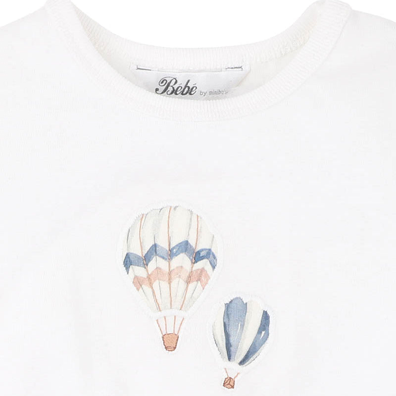 White t-shirt with hot air balloon design and 'Bebe' branding on a white background