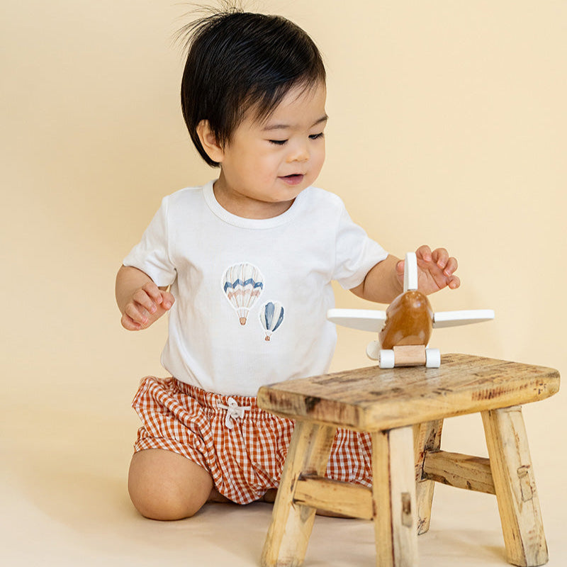 White bodysuit with hot air balloon print and rust coloured gingham shorts Set for baby
