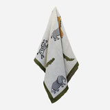 Baby blanket in neutral colour with dark green border and featuring wild animals.