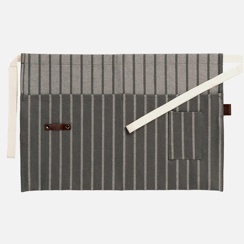 Sophie Conran waist garden apron from Burgon Ball at Cerise. Made from 100% cotton in a grey ticking stripe with leather hanging loop.  Has large of deep utililty pocket and storage for gardn tools as well as smaller pocket for keys and smaller items,