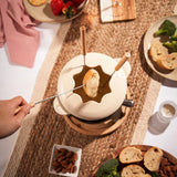 Beige coloroued fondue set on wooden base with wooden handle forks