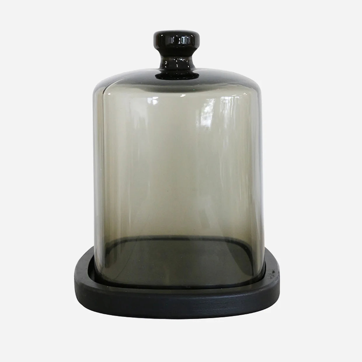 Smoke coloureed glass dome on black wooden base.
