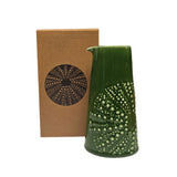 Green coloured ceramic handleless jug with embossed kina design